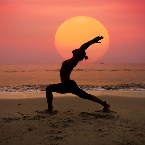 woman-practicing-yoga-with-sun-her