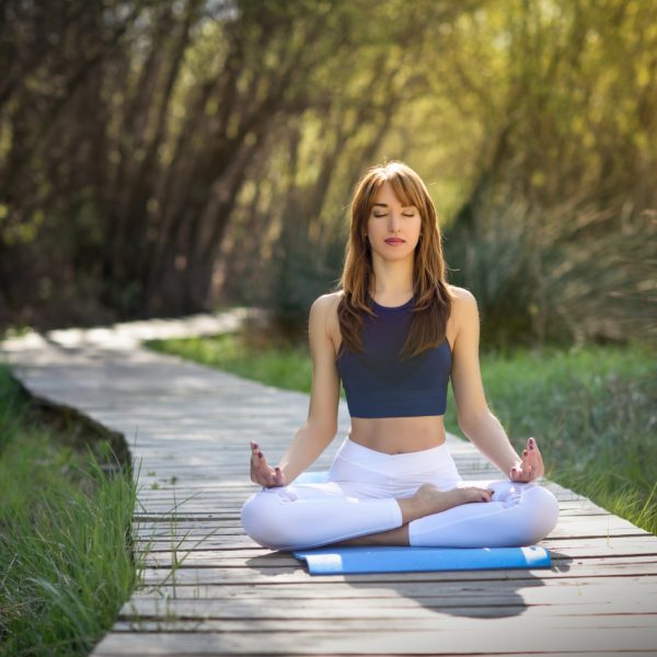 young-beautiful-woman-doing-yoga-nature